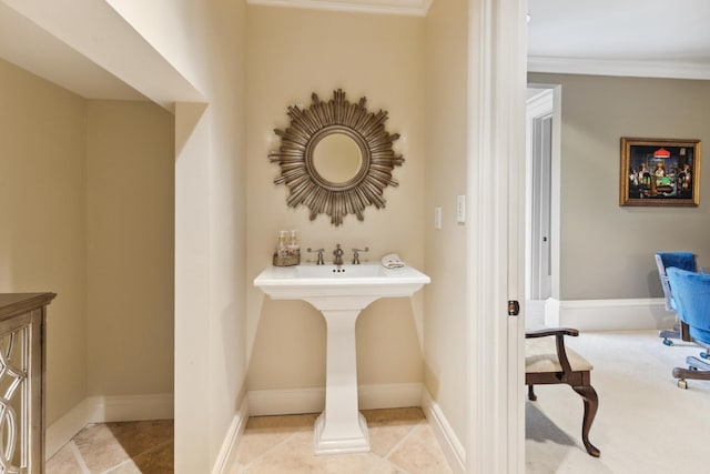 bathroom featuring tile patterned floors, crown molding, and baseboards