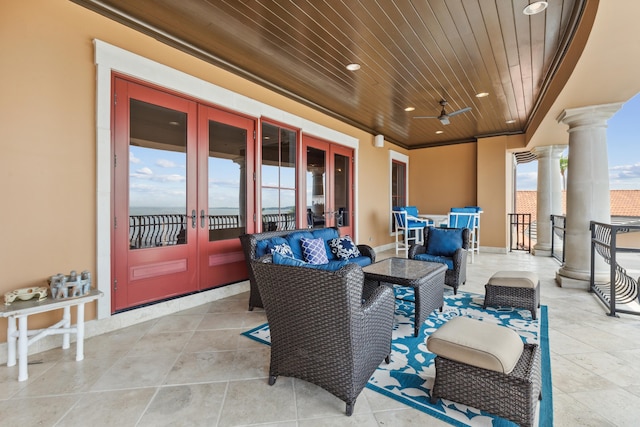 view of patio with an outdoor living space, ceiling fan, and french doors