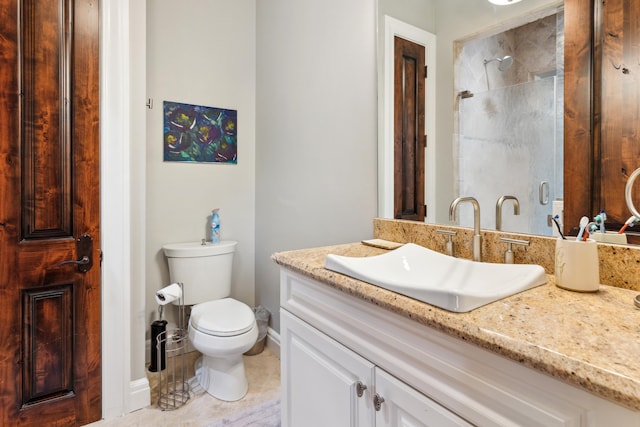 bathroom with tile patterned flooring, toilet, a tile shower, and vanity