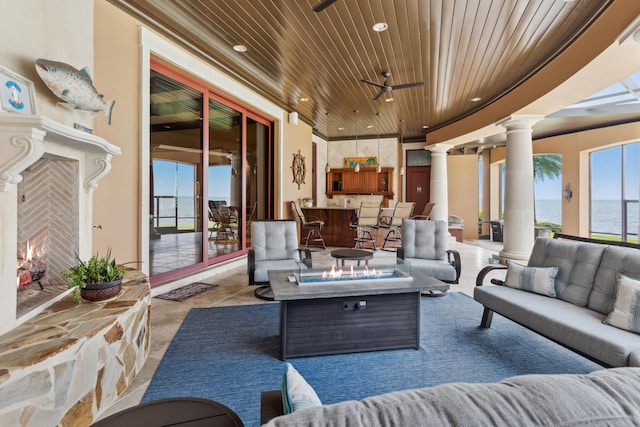 exterior space with ceiling fan, a water view, and an outdoor hangout area