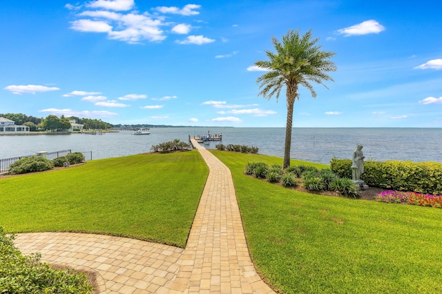 exterior space featuring a lawn and a water view