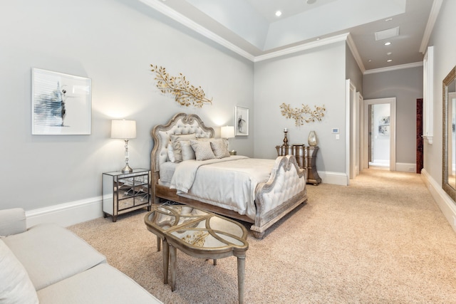 bedroom with a tray ceiling, crown molding, and light carpet