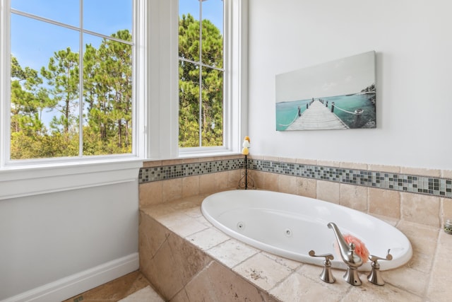 bathroom featuring baseboards and a whirlpool tub