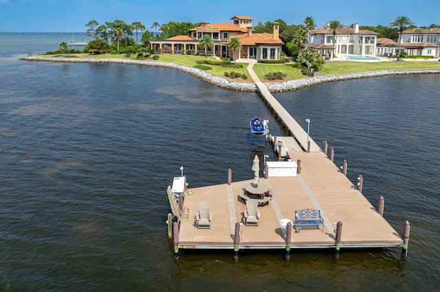 dock area featuring a water view and a yard