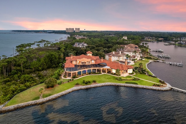 aerial view at dusk with a water view