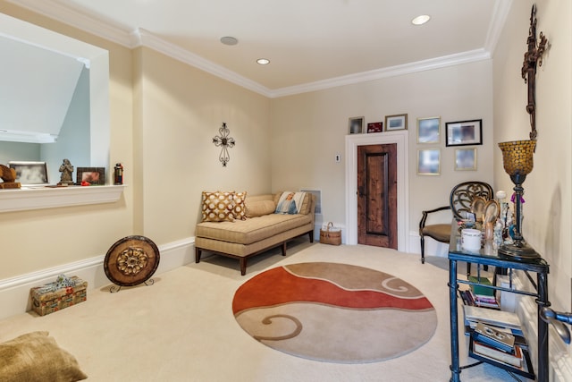 sitting room with carpet floors and crown molding