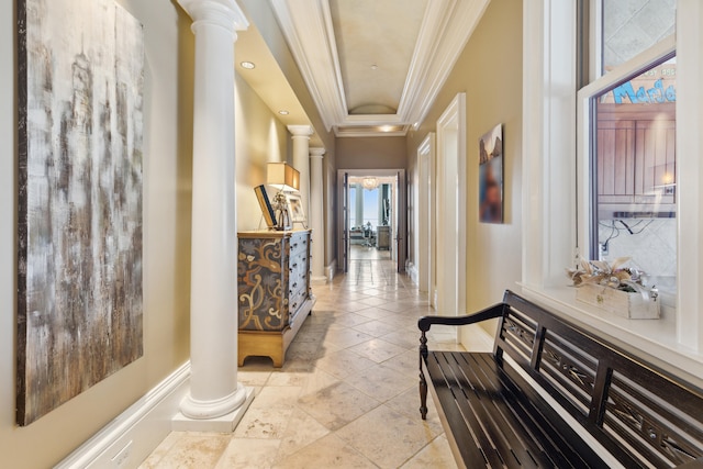 corridor with ornate columns, a raised ceiling, light tile patterned floors, and crown molding