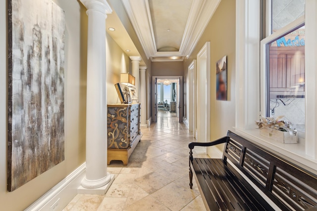 corridor with decorative columns, ornamental molding, and baseboards
