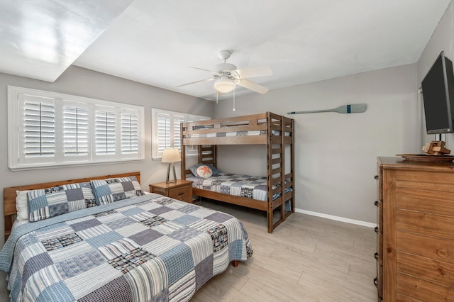 bedroom with light wood finished floors, ceiling fan, and baseboards