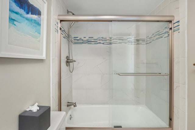 bathroom with bath / shower combo with glass door