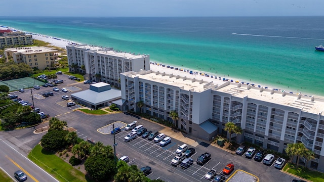 birds eye view of property featuring a beach view and a water view