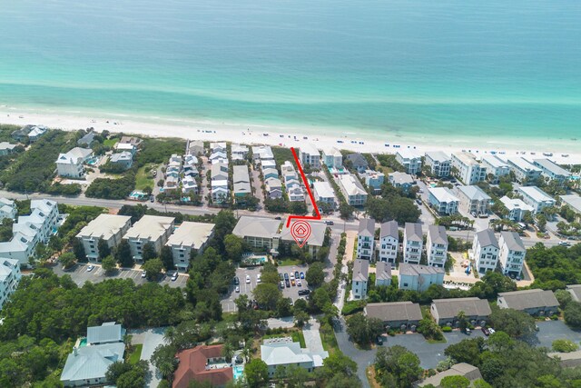 drone / aerial view with a water view and a beach view