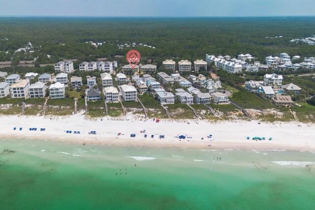 birds eye view of property with a water view and a view of the beach