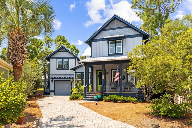 view of front of property featuring covered porch and a garage