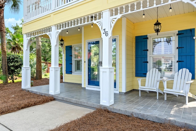 exterior space featuring a balcony and covered porch