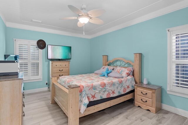 bedroom featuring ceiling fan, light wood-type flooring, and ornamental molding