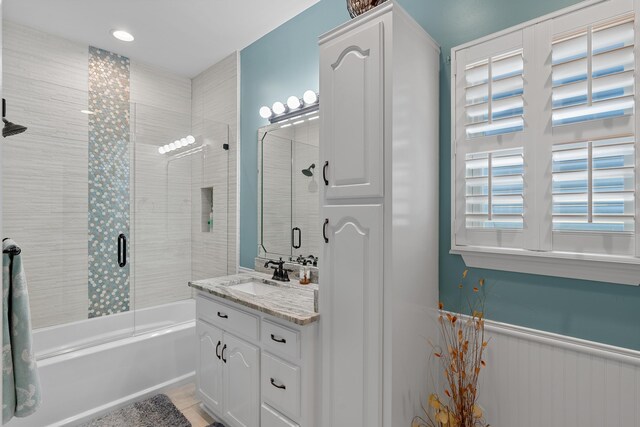 bathroom featuring enclosed tub / shower combo, vanity, and tile patterned flooring