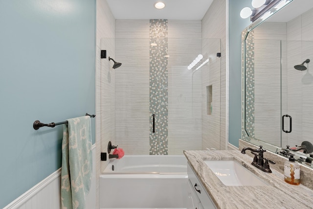 bathroom featuring enclosed tub / shower combo and vanity