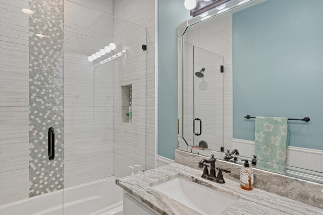 bathroom with shower / bath combination with glass door and vanity