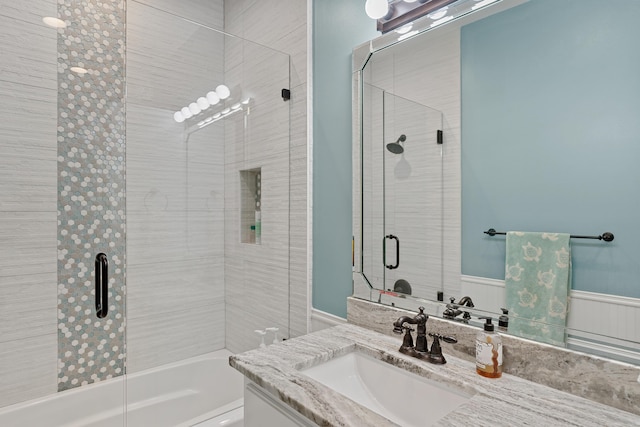 bathroom with vanity and combined bath / shower with glass door