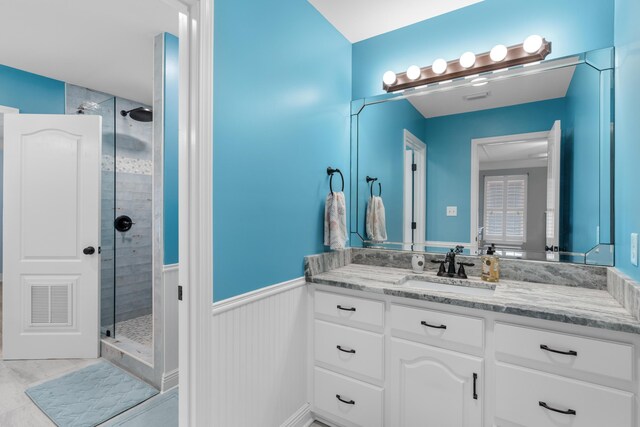 bathroom with vanity, a shower with shower door, and tile patterned flooring