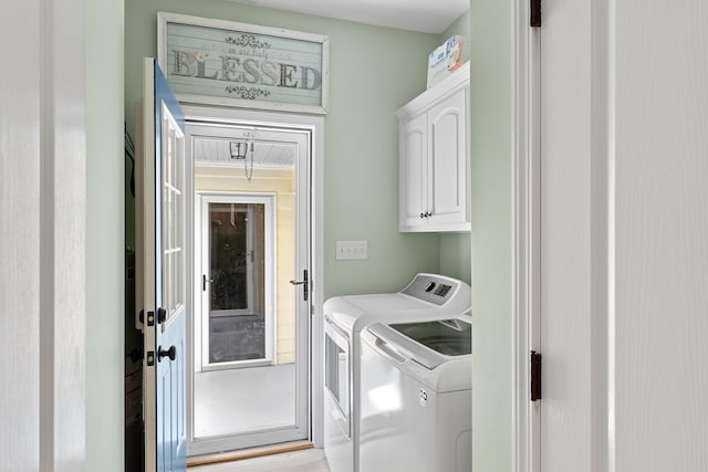 laundry room with cabinets and washer and dryer