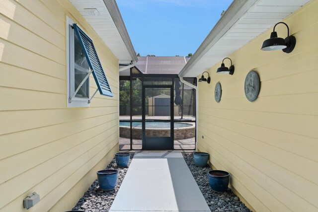 view of side of home with glass enclosure and a swimming pool