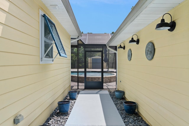 view of home's exterior with a patio and glass enclosure