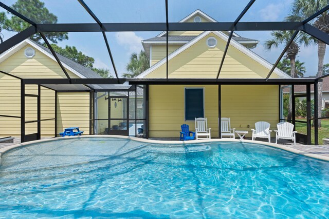 view of swimming pool with glass enclosure and a patio