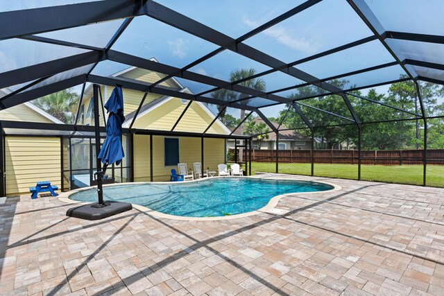 view of pool with a lanai, a yard, and a patio area