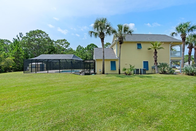 view of yard featuring cooling unit and glass enclosure