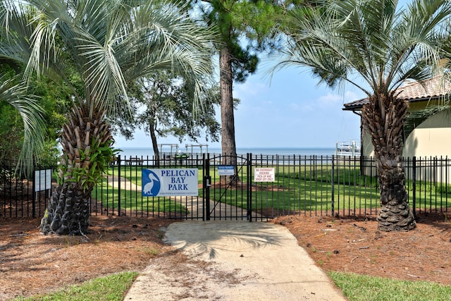 view of gate featuring a yard and a water view