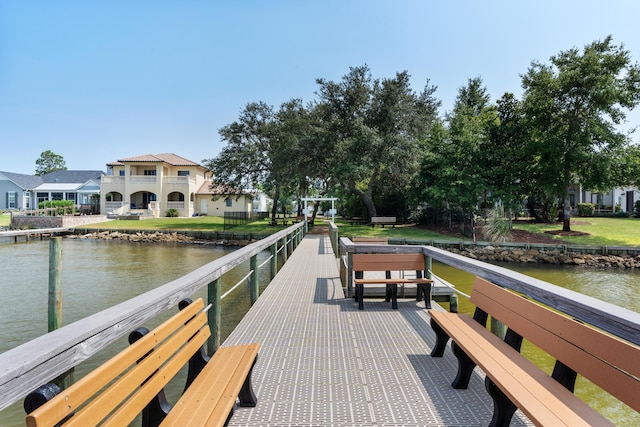 dock area with a water view and a balcony