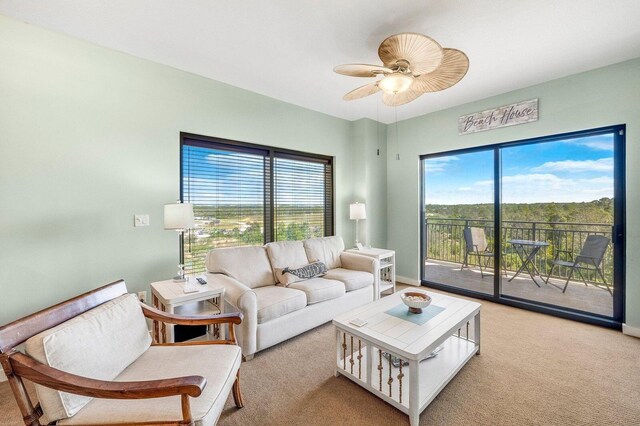 carpeted living room featuring ceiling fan