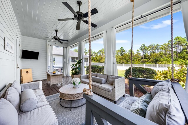 sunroom featuring ceiling fan