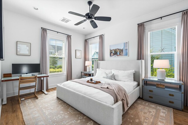 bedroom with ceiling fan and light wood-type flooring