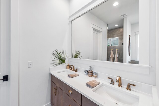 bathroom with walk in shower and vanity