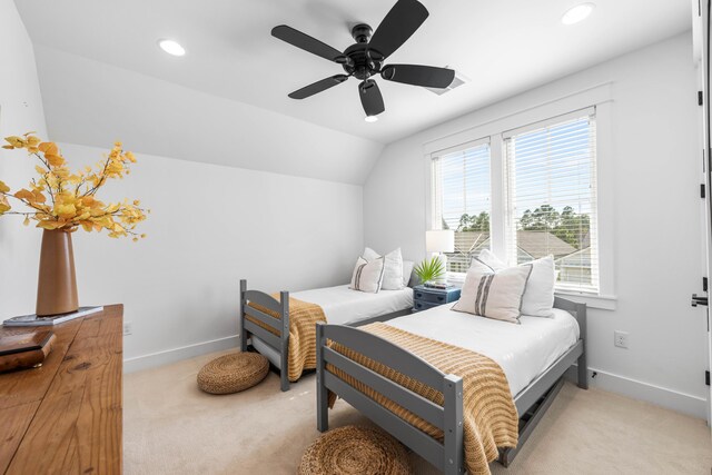 bedroom with light carpet, vaulted ceiling, and ceiling fan