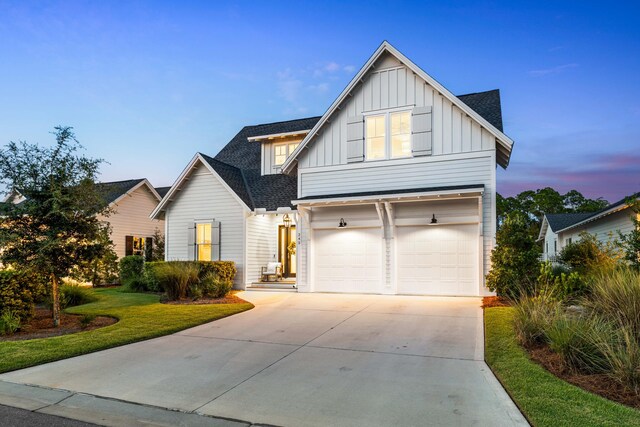 view of front facade featuring a garage and a lawn