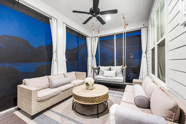 sunroom / solarium featuring ceiling fan