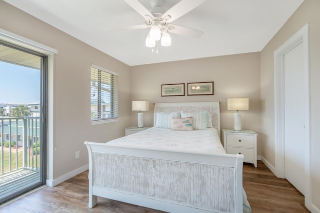 bedroom featuring access to exterior, wood-type flooring, and ceiling fan