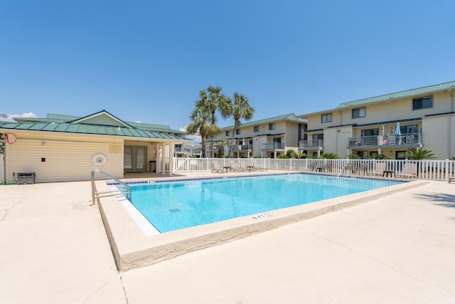 view of swimming pool with a patio