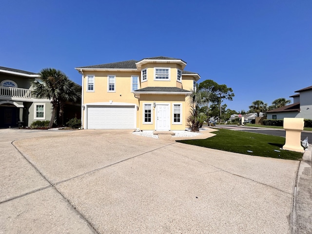 view of front of house with a garage and a front yard