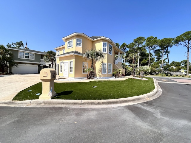 view of front facade featuring a garage and a front lawn