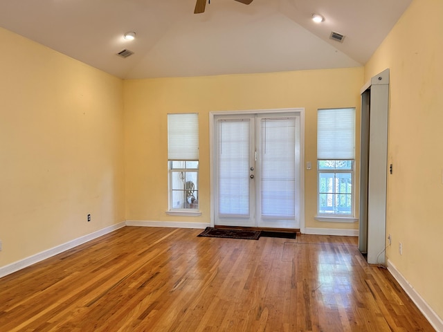 foyer with lofted ceiling, light hardwood / wood-style flooring, french doors, and ceiling fan