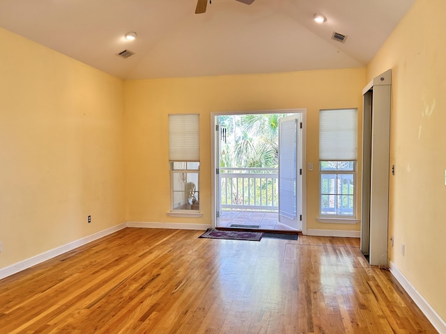 interior space with ceiling fan, lofted ceiling, and light wood-type flooring