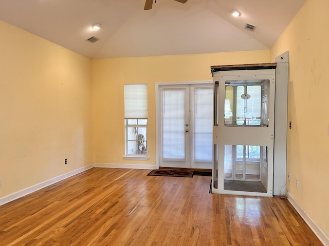 entrance foyer with ceiling fan, vaulted ceiling, and light wood-type flooring