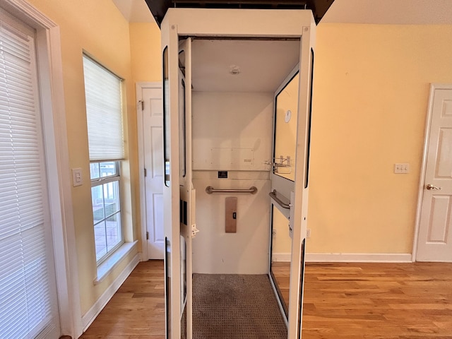 hall with light hardwood / wood-style floors