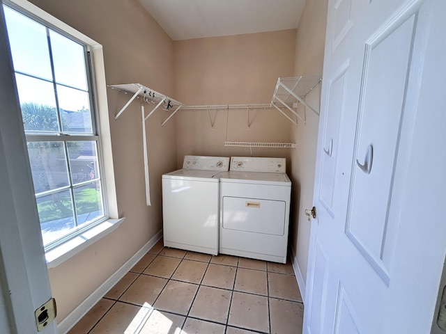 laundry area featuring washer and clothes dryer and light tile patterned floors