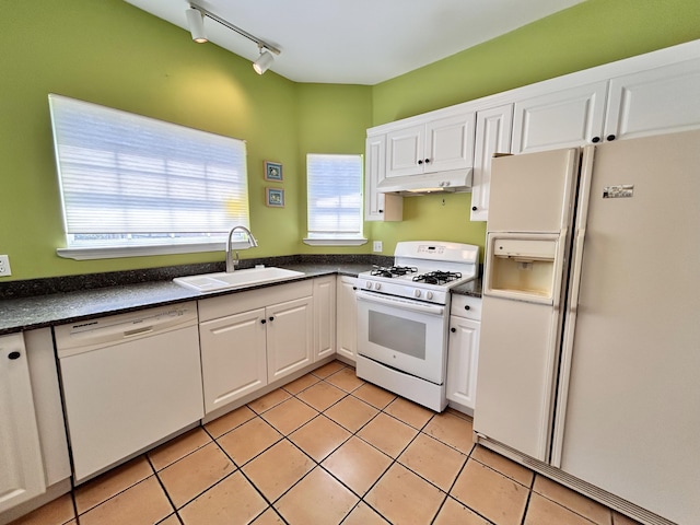 kitchen featuring white cabinetry, sink, light tile patterned floors, and white appliances